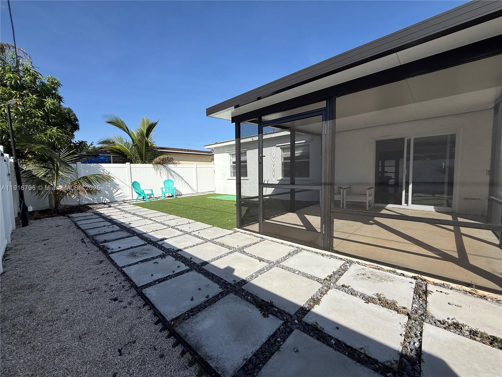 8636 Beekman Drive, Unit 8636 Miramar, FL 33025 - Photo 16 of 18 a view of a backyard with two chairs and a table