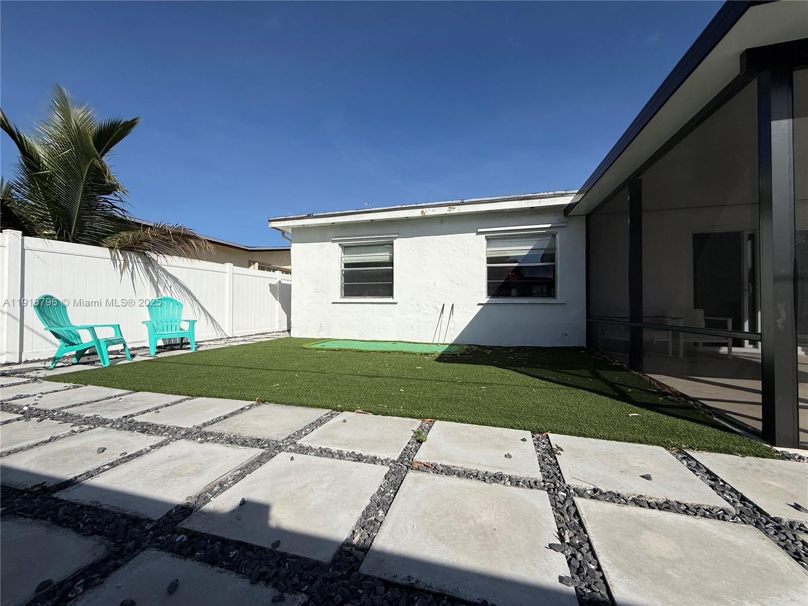 8636 Beekman Drive, Unit 8636 Miramar, FL 33025 - Photo 17 of 18 a front view of a house with a yard and garage