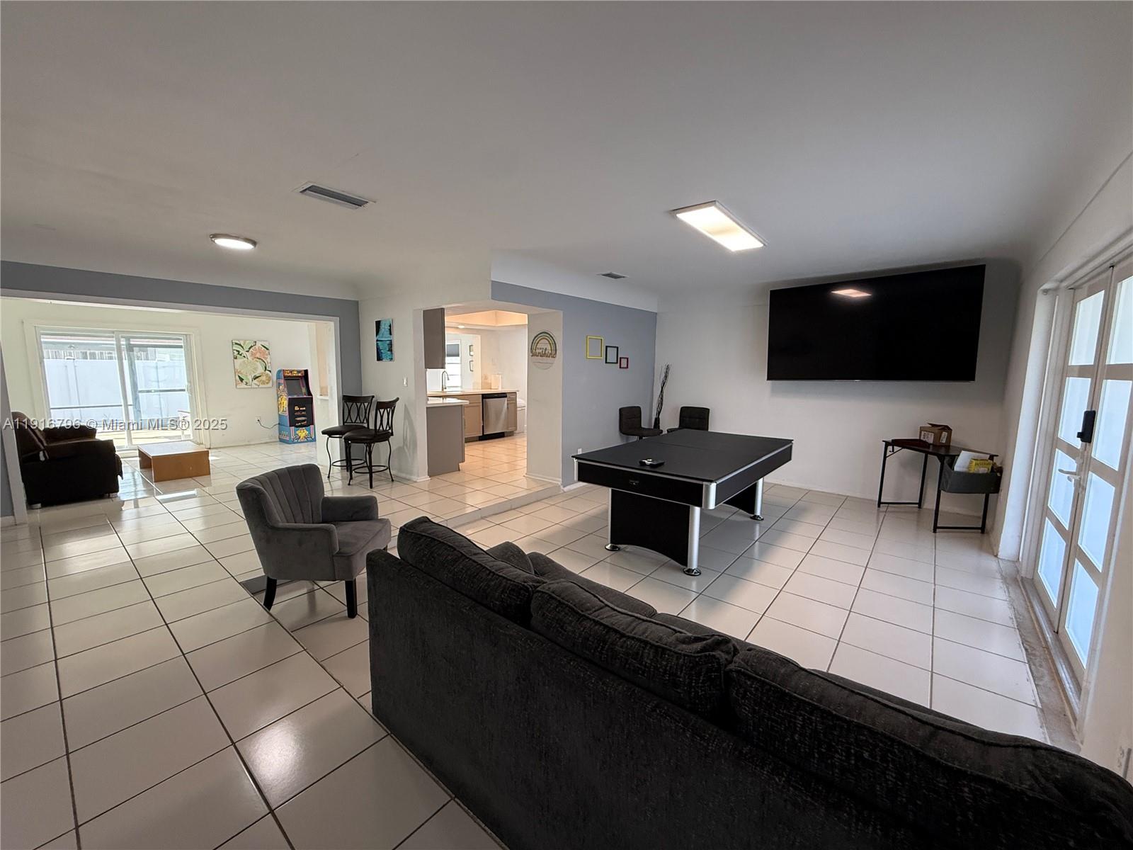 8636 Beekman Drive, Unit 8636 Miramar, FL 33025 - Photo 2 of 18 a living room with furniture and a flat screen tv