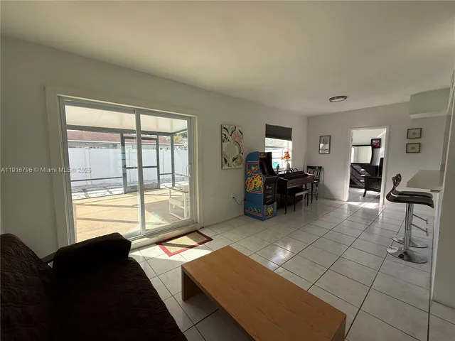 a living room with furniture and large windows