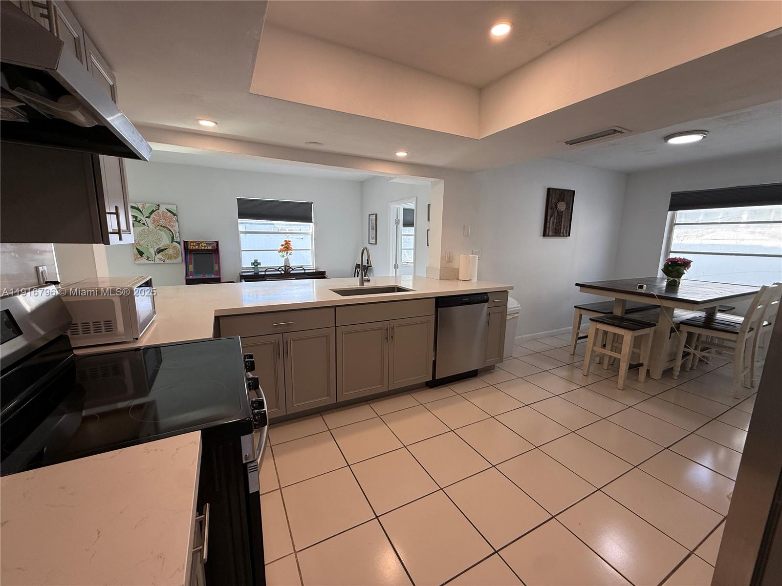 8636 Beekman Drive, Unit 8636 Miramar, FL 33025 - Photo 7 of 18 a kitchen with a sink and chairs