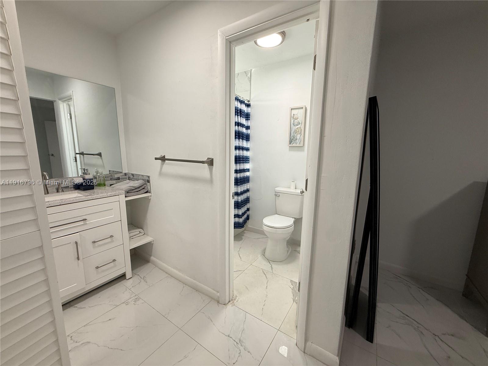 8636 Beekman Drive, Unit 8636 Miramar, FL 33025 - Photo 9 of 18 a bathroom with a sink and a mirror