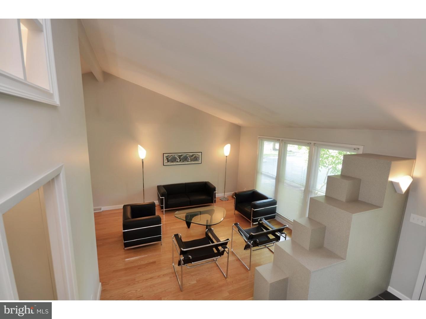 32 Penn Lyle Road Princeton Junction, NJ 08550 - Photo 14 of 25 a living room with furniture a flat screen tv and a refrigerator