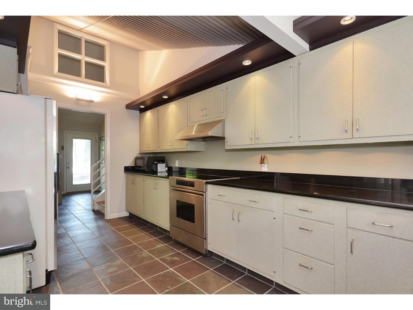 32 Penn Lyle Road Princeton Junction, NJ 08550 - Photo 8 of 25 a kitchen with granite countertop a stove a sink and white cabinets