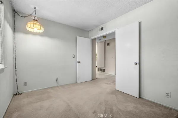 an empty room with a window and wooden floor