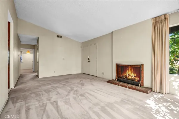 a view of an empty room with a fireplace