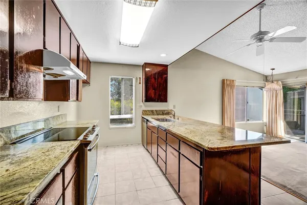 a kitchen with stainless steel appliances granite countertop a sink and stove