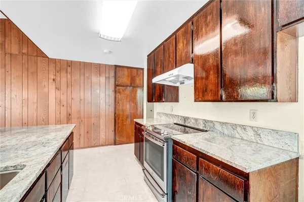 a kitchen with stainless steel appliances granite countertop a sink and a stove