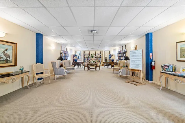 a living room with furniture a rug and a projector