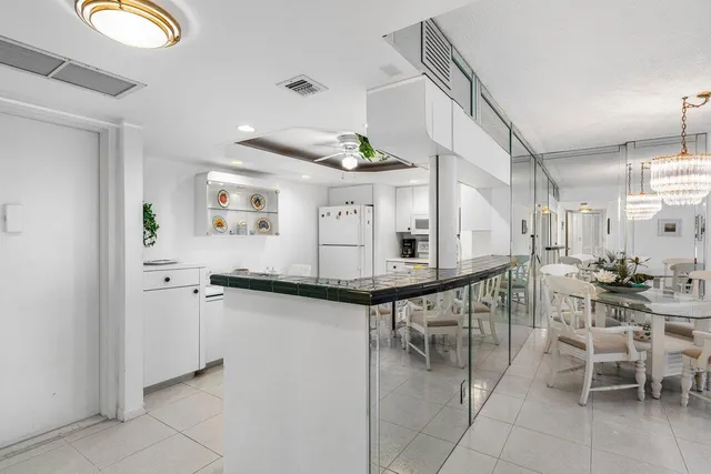 a living room with couches a dining table and chairs with wooden floor