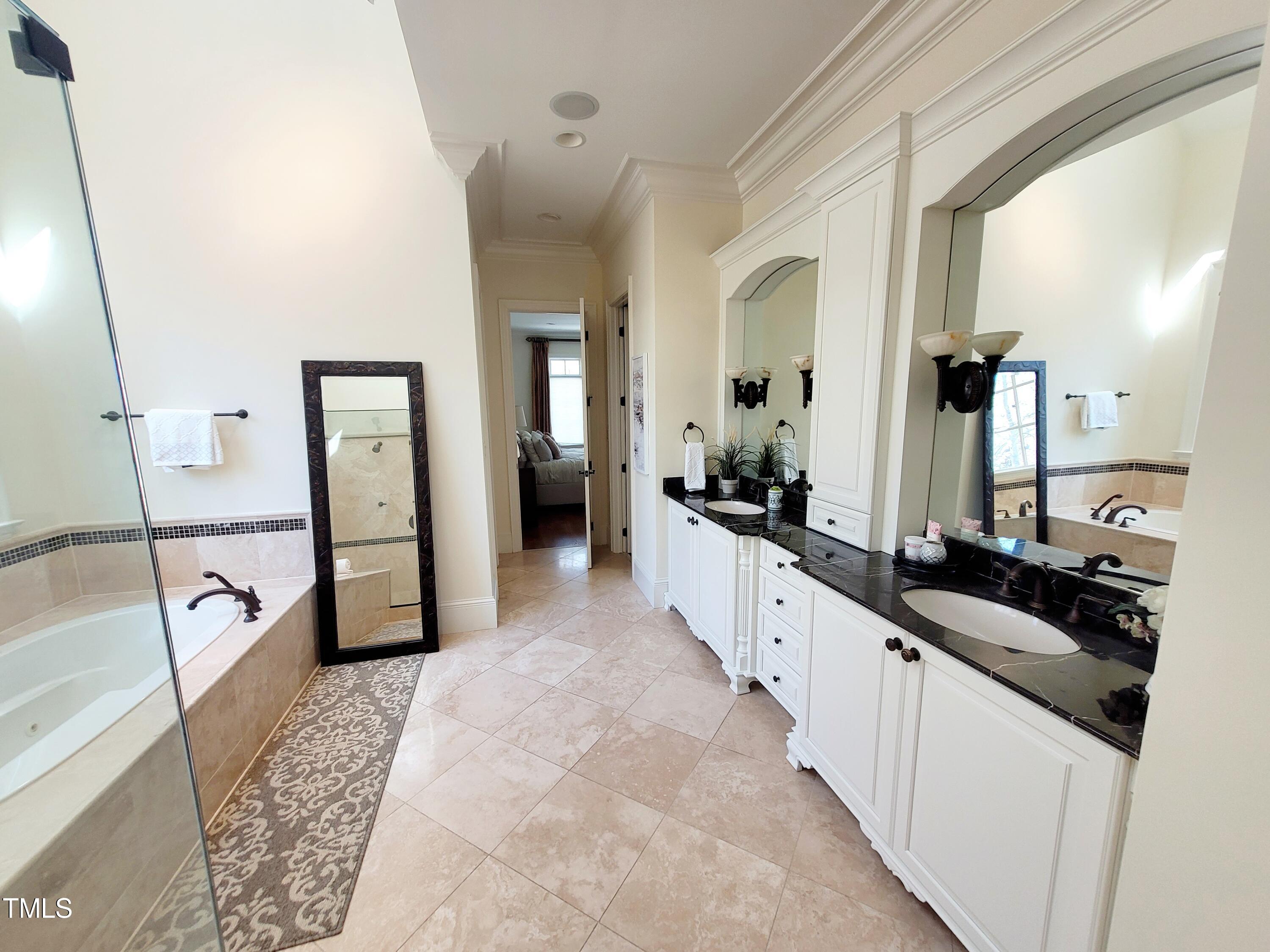 11216 Jonas Ridge Lane Raleigh, NC 27613 - Photo 12 of 75 Owner's Bath: Experience the Height of Luxury with Vaulted Ceilings, Skylights, Steam Shower, Soaking Tub and seperate toliet room