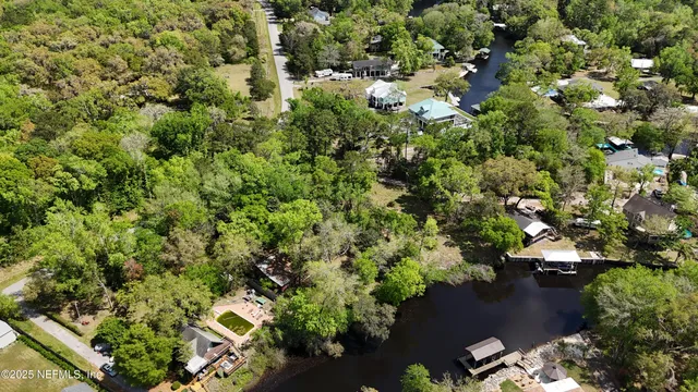 an aerial view of a houses with yard