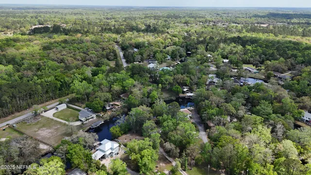 an aerial view of a houses with a yard