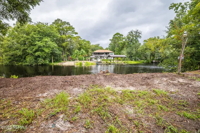 a view of a lake with a house in the background