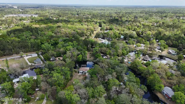 an aerial view of a houses with a yard