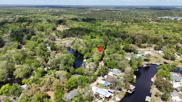 an aerial view of a houses with a yard