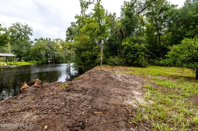 a backyard of a house with a lake view