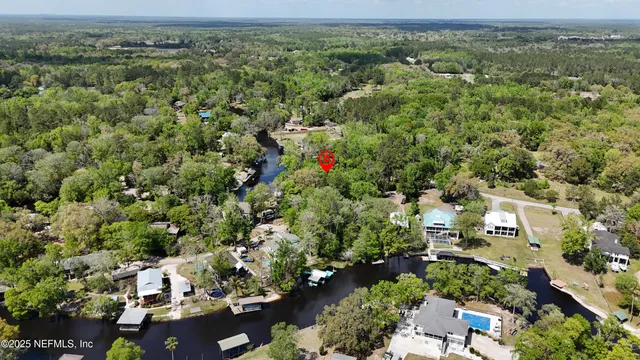 an aerial view of a houses with a yard