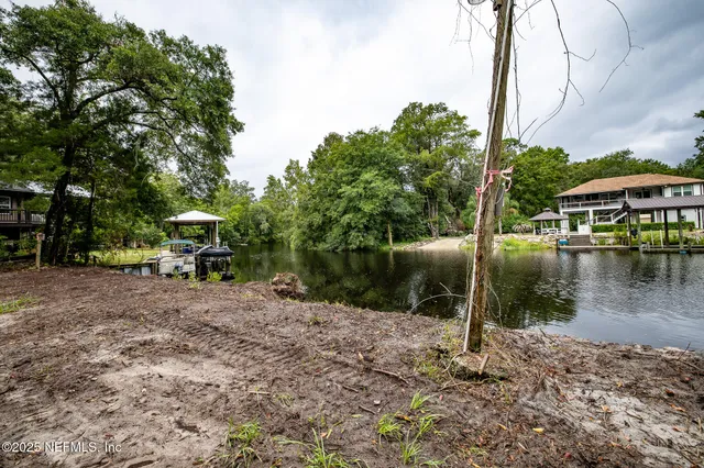 a view of a lake with a house in the background