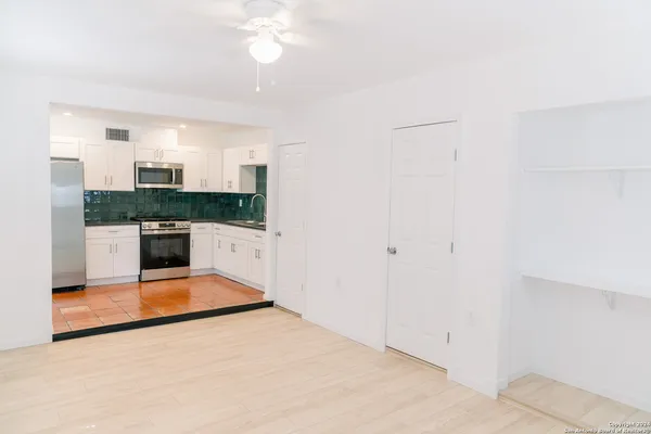 a view of kitchen with a sink and a refrigerator