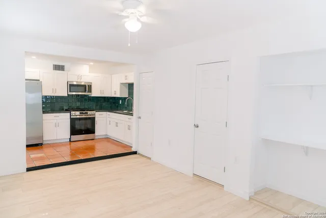 a view of kitchen with a sink and a refrigerator