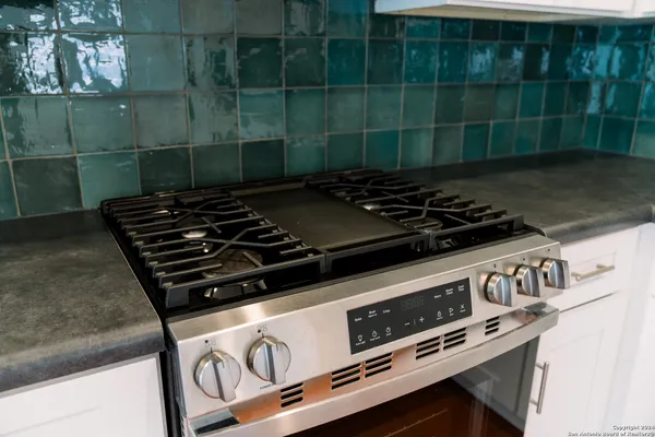 a stove top oven sitting inside of a kitchen