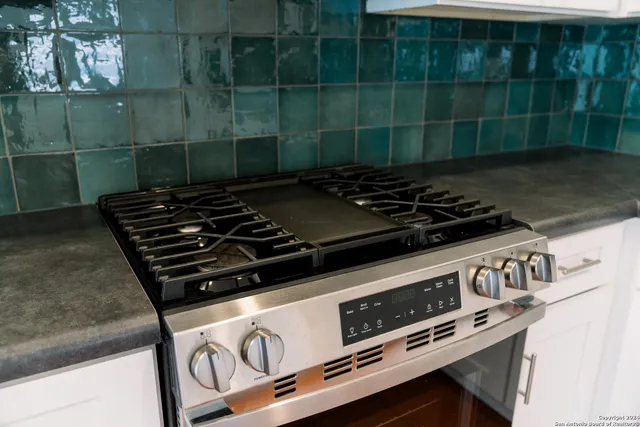 a stove top oven sitting inside of a kitchen