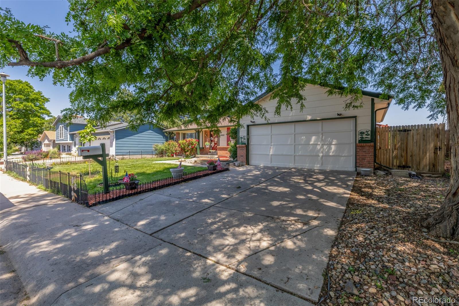 18083 East Atlantic Drive Aurora, CO 80013 - Photo 2 of 22 a front view of a house with a yard and garage