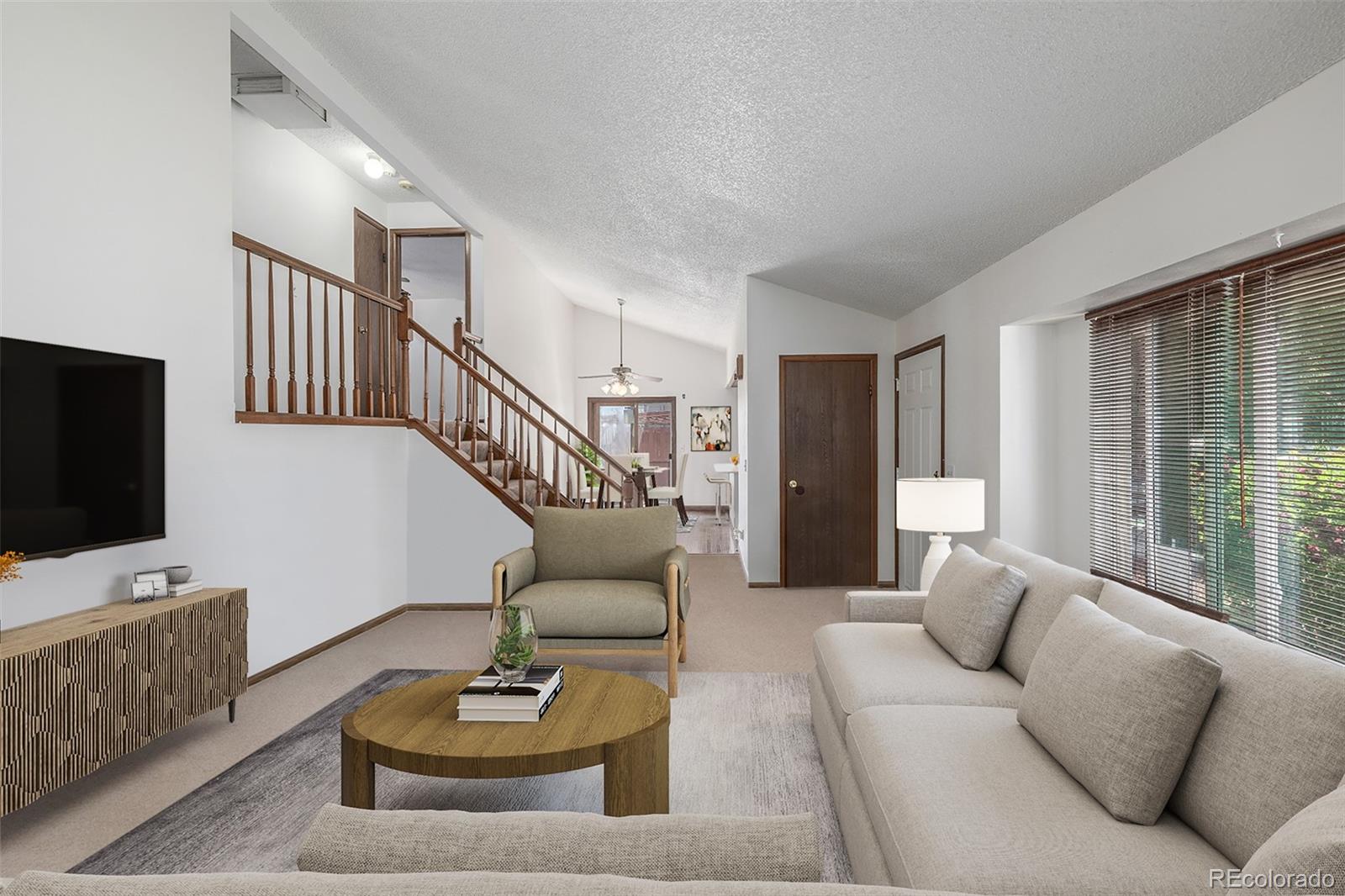 18083 East Atlantic Drive Aurora, CO 80013 - Photo 4 of 22 a living room with furniture and a flat screen tv