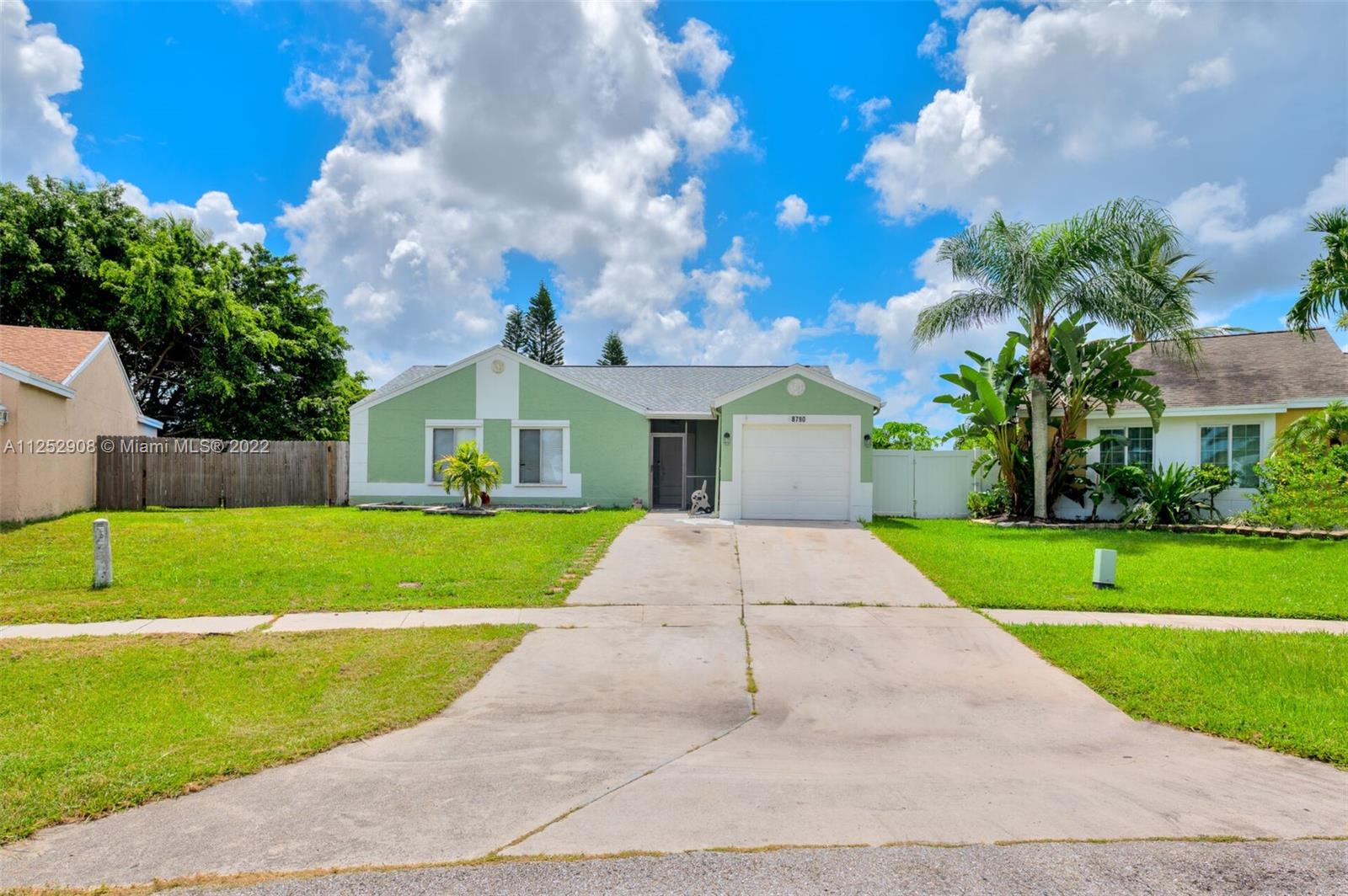 18790 Cloud Lake Circle Boca Raton, FL 33496 - Photo 1 of 27 a front view of a house with a yard and garage