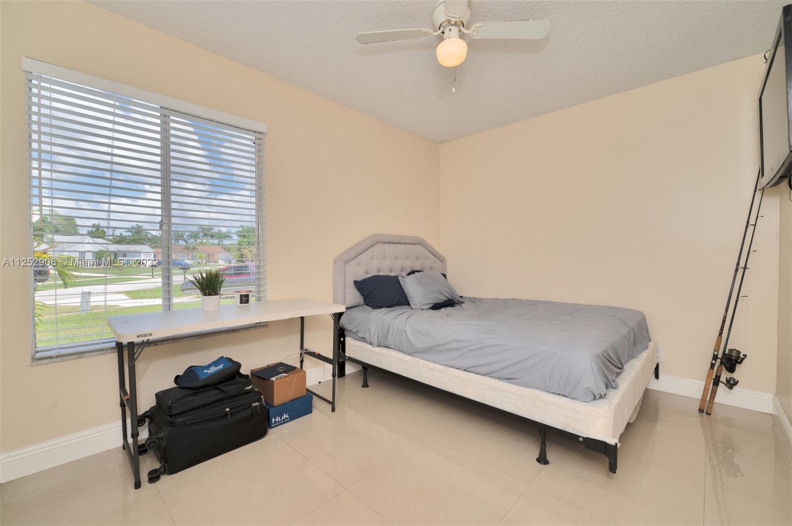 18790 Cloud Lake Circle Boca Raton, FL 33496 - Photo 13 of 27 a bedroom with a bed and a window