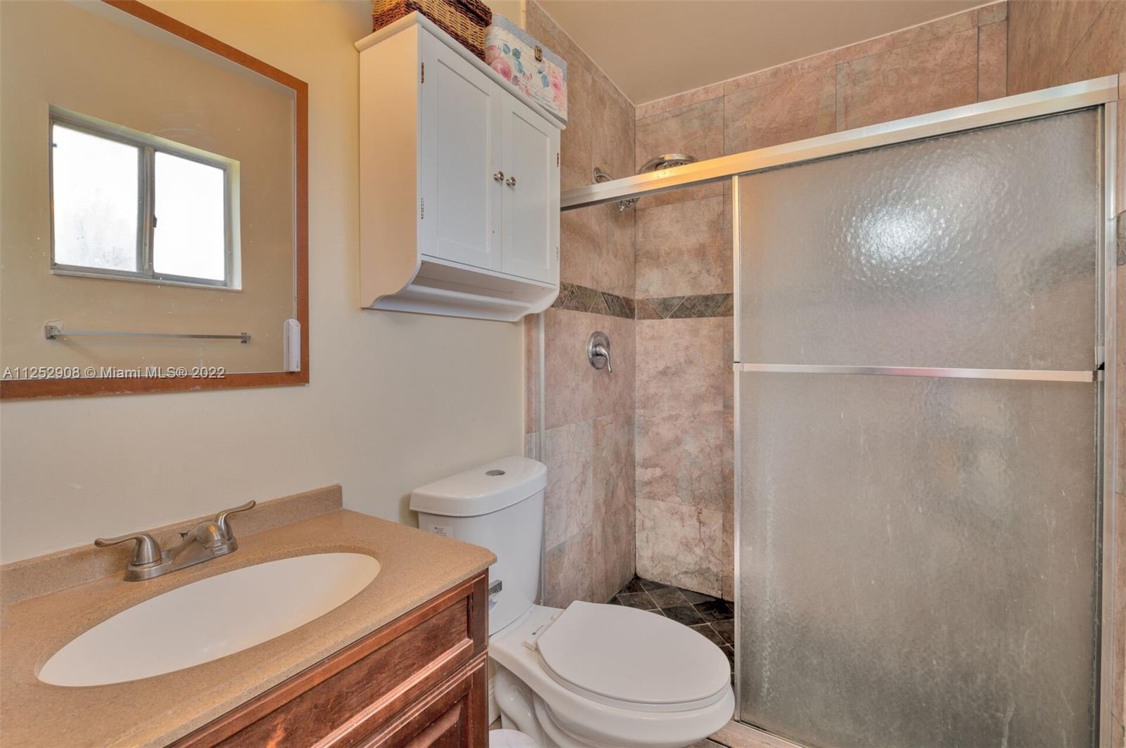 18790 Cloud Lake Circle Boca Raton, FL 33496 - Photo 15 of 27 a bathroom with a sink a toilet and shower