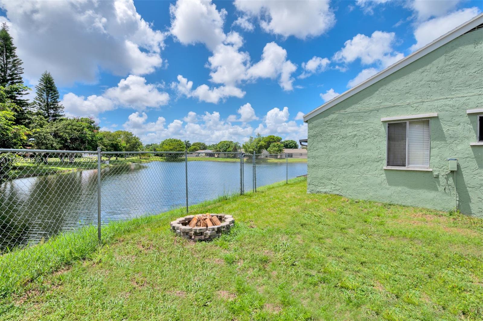 18790 Cloud Lake Circle Boca Raton, FL 33496 - Photo 20 of 27 a view of a lake with a house in the background