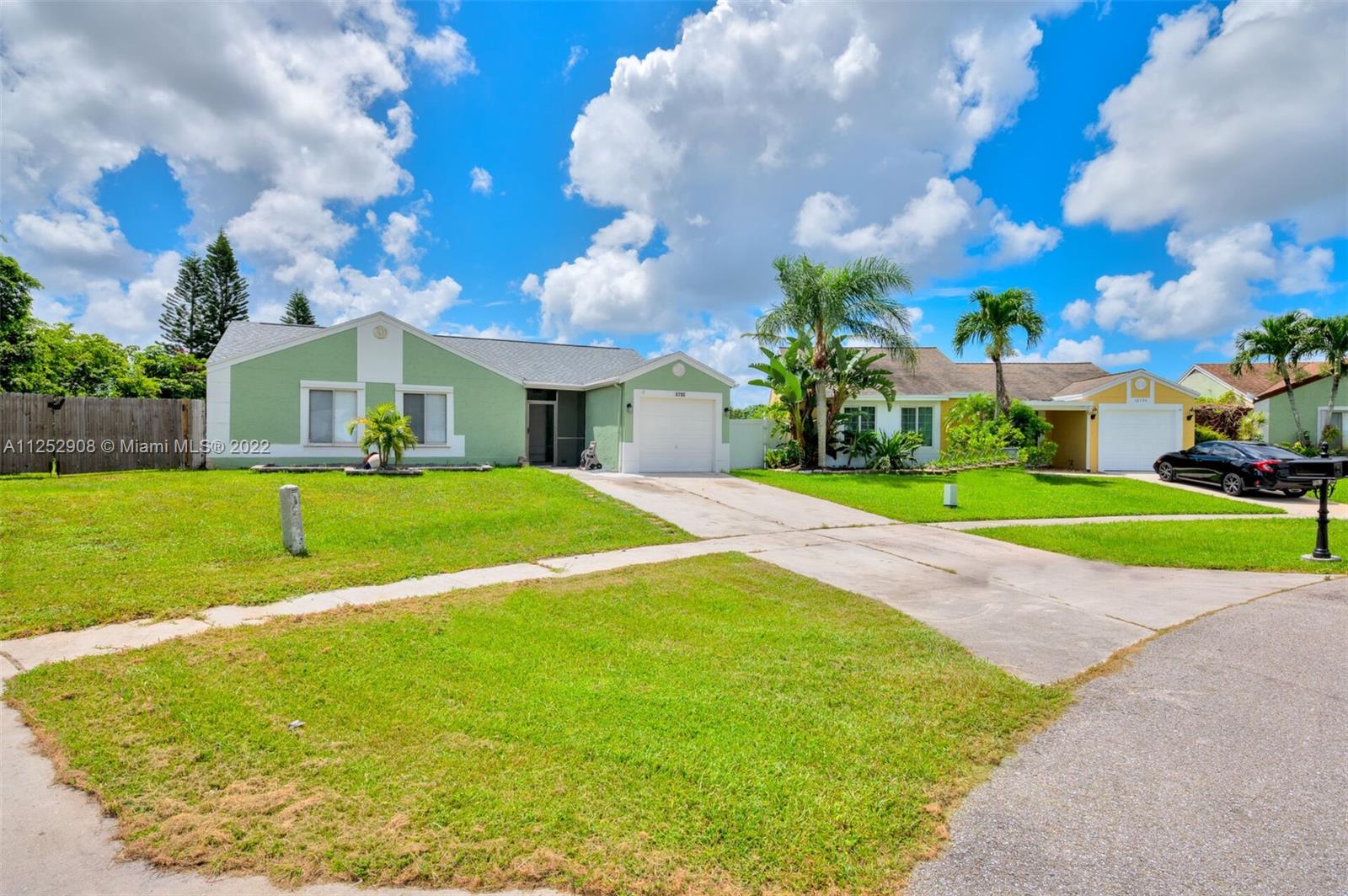 18790 Cloud Lake Circle Boca Raton, FL 33496 - Photo 2 of 27 a view of a house with a big yard and potted plants