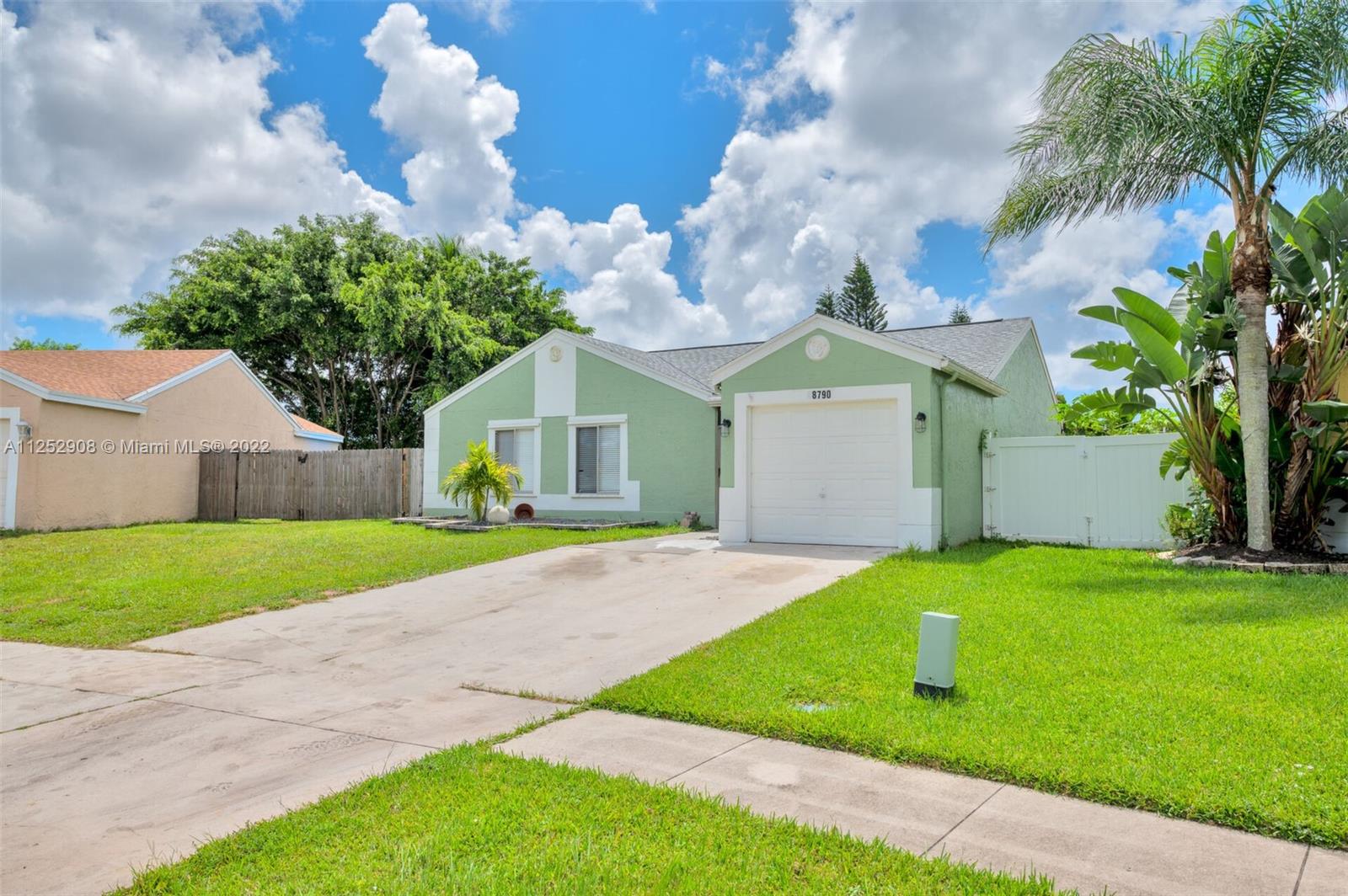 18790 Cloud Lake Circle Boca Raton, FL 33496 - Photo 3 of 27 a front view of a house with garden