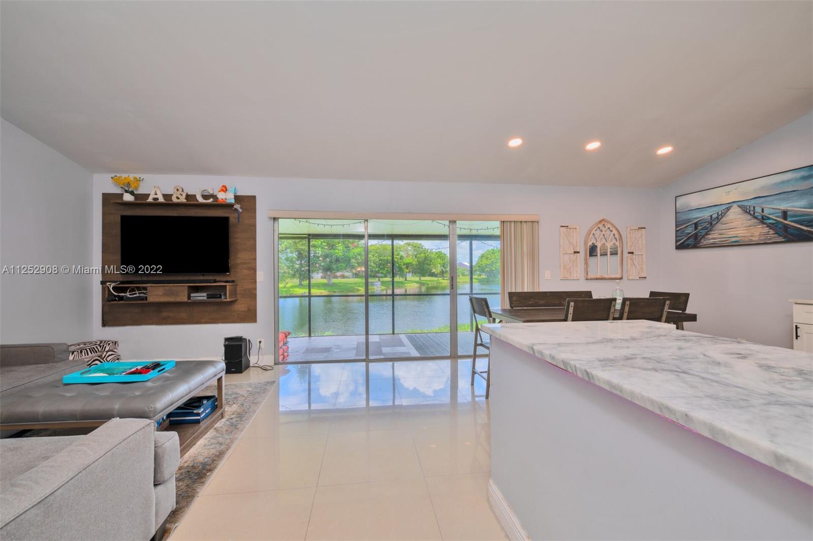 18790 Cloud Lake Circle Boca Raton, FL 33496 - Photo 5 of 27 a living room with furniture and a flat screen tv