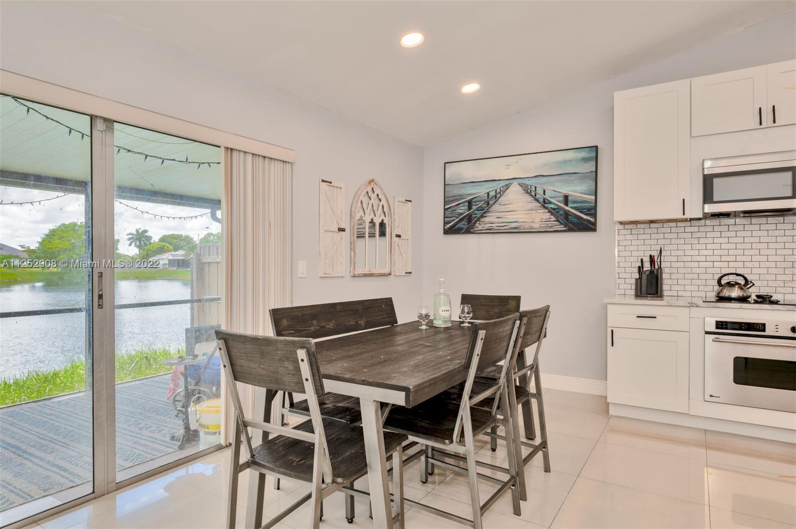 18790 Cloud Lake Circle Boca Raton, FL 33496 - Photo 9 of 27 a view of a dining room with furniture and a potted plant