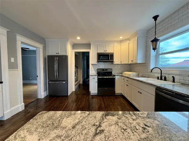 a kitchen with a refrigerator a sink and a stove