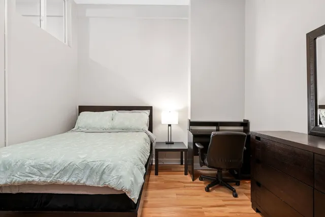 a bedroom with a bed and a chair