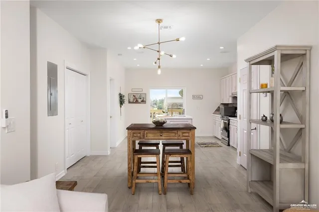 a view of a a dining room with furniture window and wooden floor