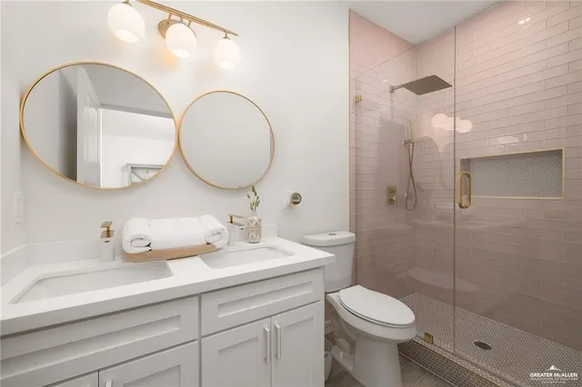 a bathroom with a toilet a sink and mirror