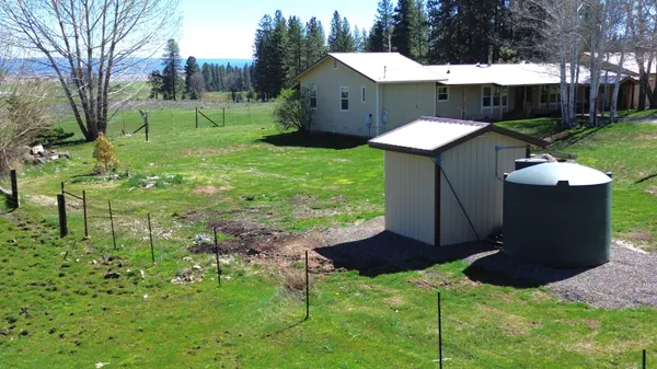 a view of a backyard with a fountain and a fire pit