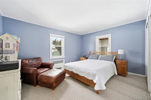 a bedroom with a bed couch and window