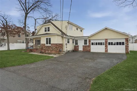 a front view of a house with a garden and yard