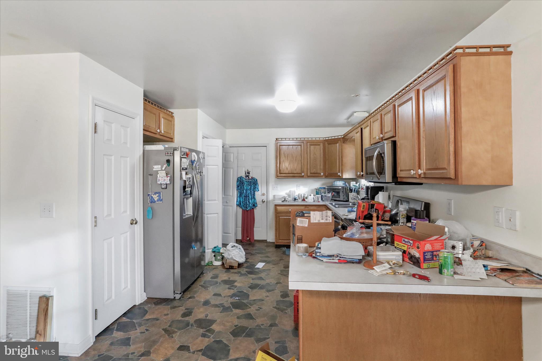 35 Waterstone Lane Berkeley Springs, WV 25411 - Photo 12 of 38 a room with stainless steel appliances granite countertop a refrigerator sink stove and cabinets
