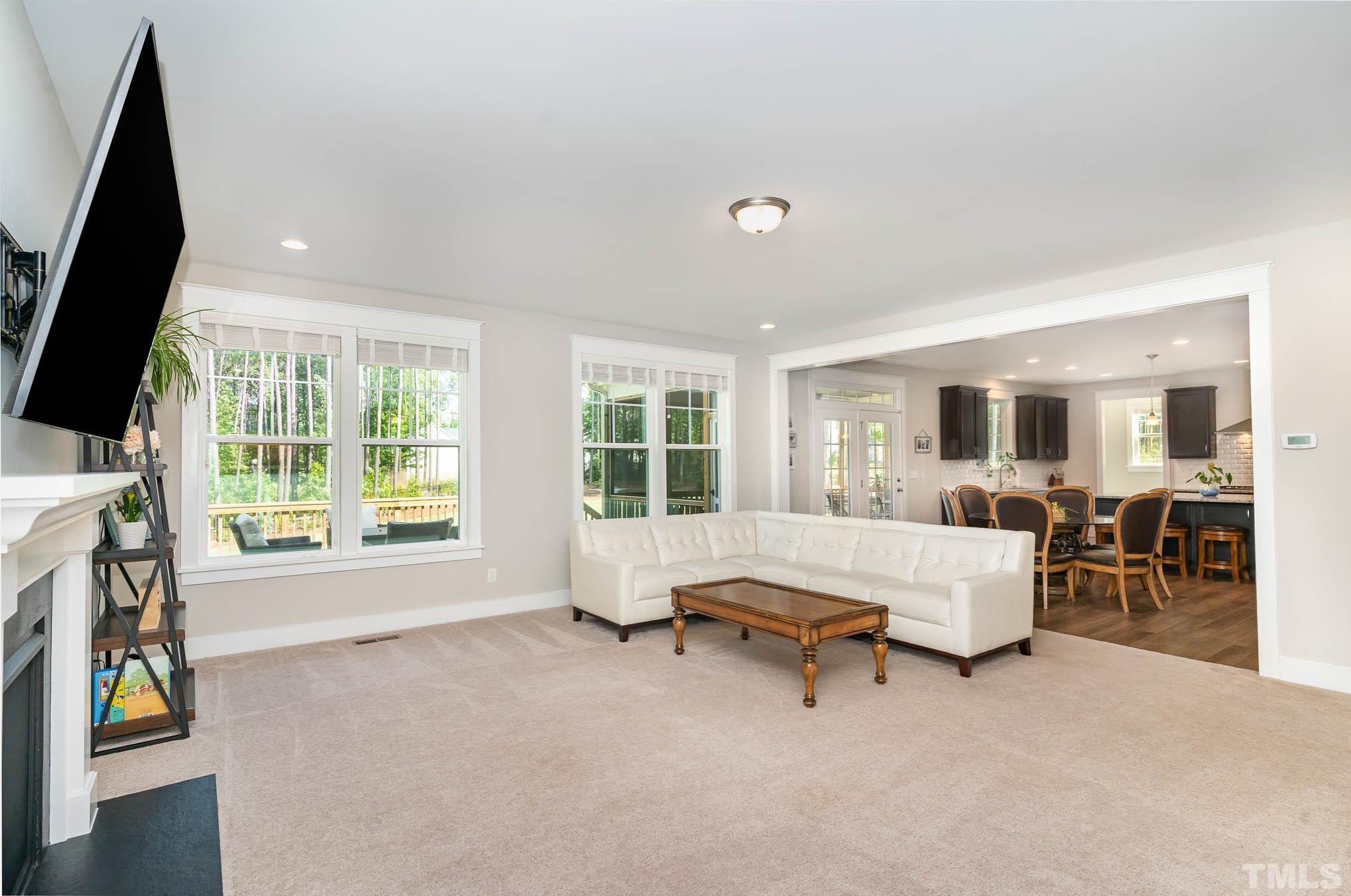 2816 Flume Gate Drive Raleigh, NC 27603 - Photo 12 of 45 a living room with furniture and a flat screen tv