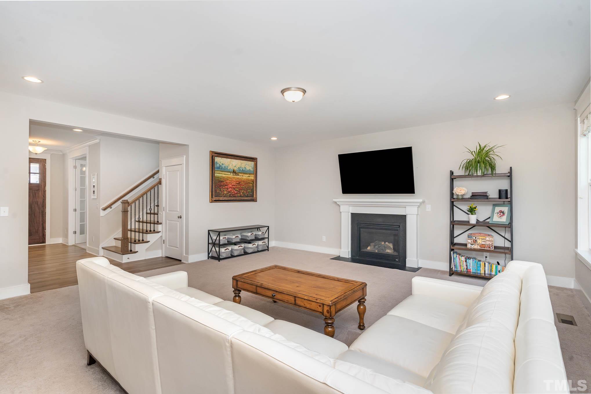2816 Flume Gate Drive Raleigh, NC 27603 - Photo 13 of 45 a living room with fireplace furniture and a flat screen tv