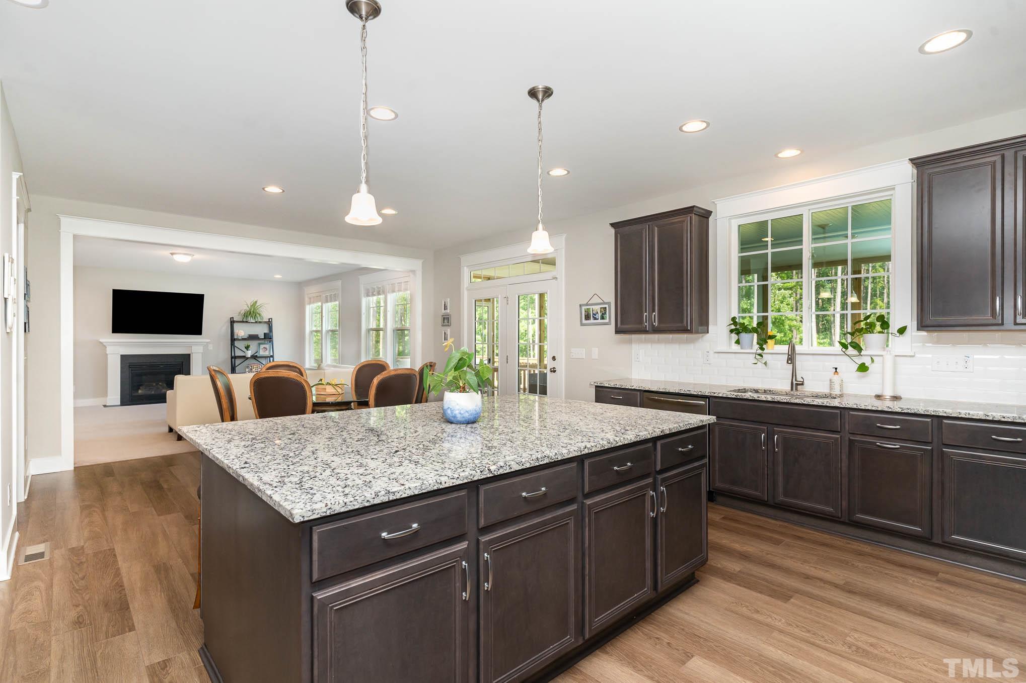 2816 Flume Gate Drive Raleigh, NC 27603 - Photo 17 of 45 a kitchen with center island a sink dishwasher stove and wooden cabinets