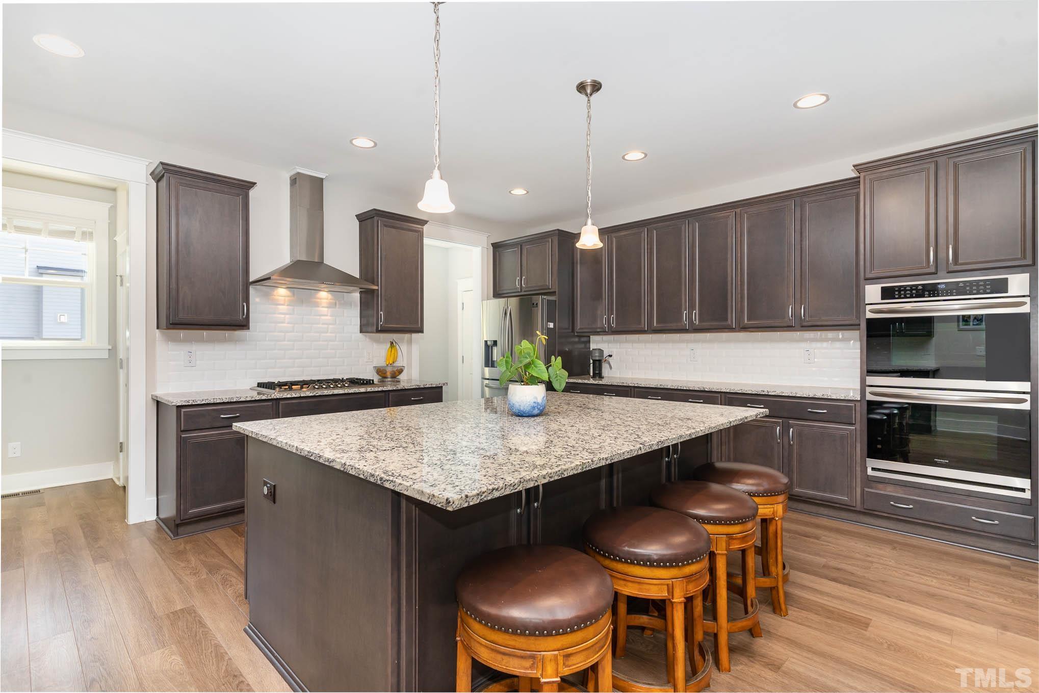 2816 Flume Gate Drive Raleigh, NC 27603 - Photo 18 of 45 a kitchen with a table chairs microwave and cabinets