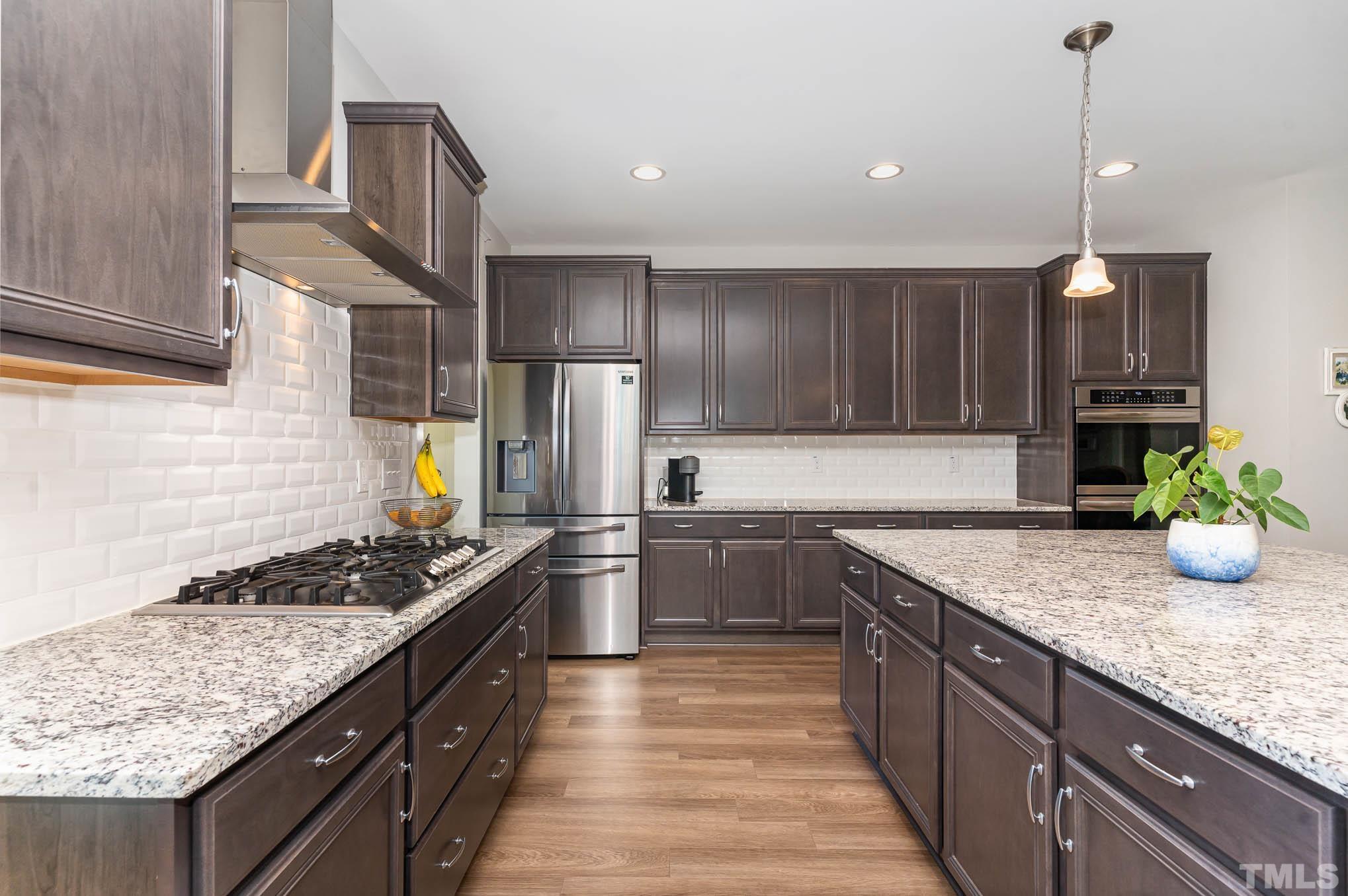 2816 Flume Gate Drive Raleigh, NC 27603 - Photo 19 of 45 a kitchen with stainless steel appliances granite countertop a sink stove and refrigerator